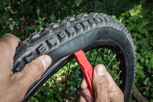 HOW TO USE TIRE LEVERS TO REMOVE AND REINSTALL A BICYCLE TIRE